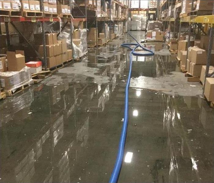 Flooded warehouse with SERVPRO water extracting equipment